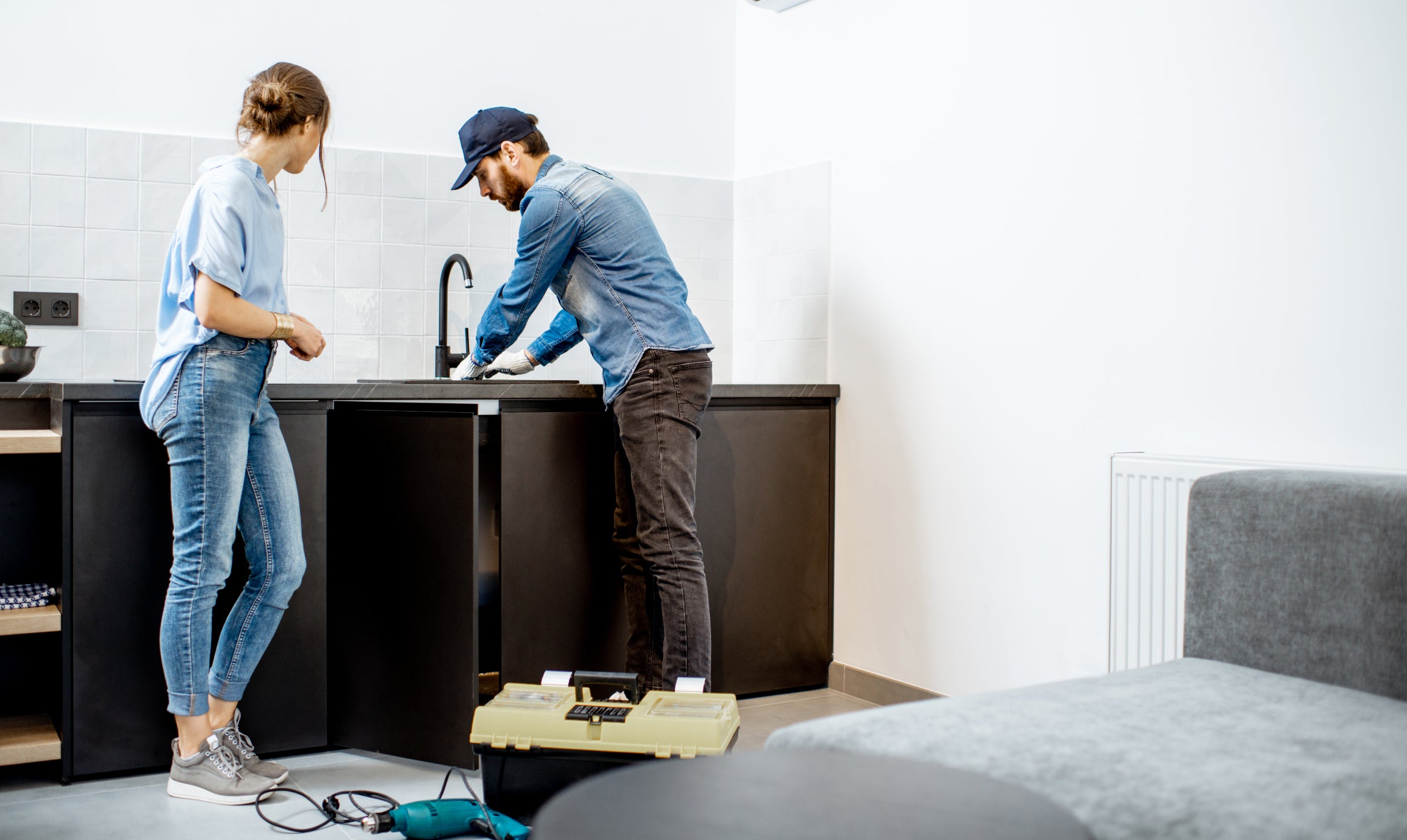 Plumber with lady working on a sink